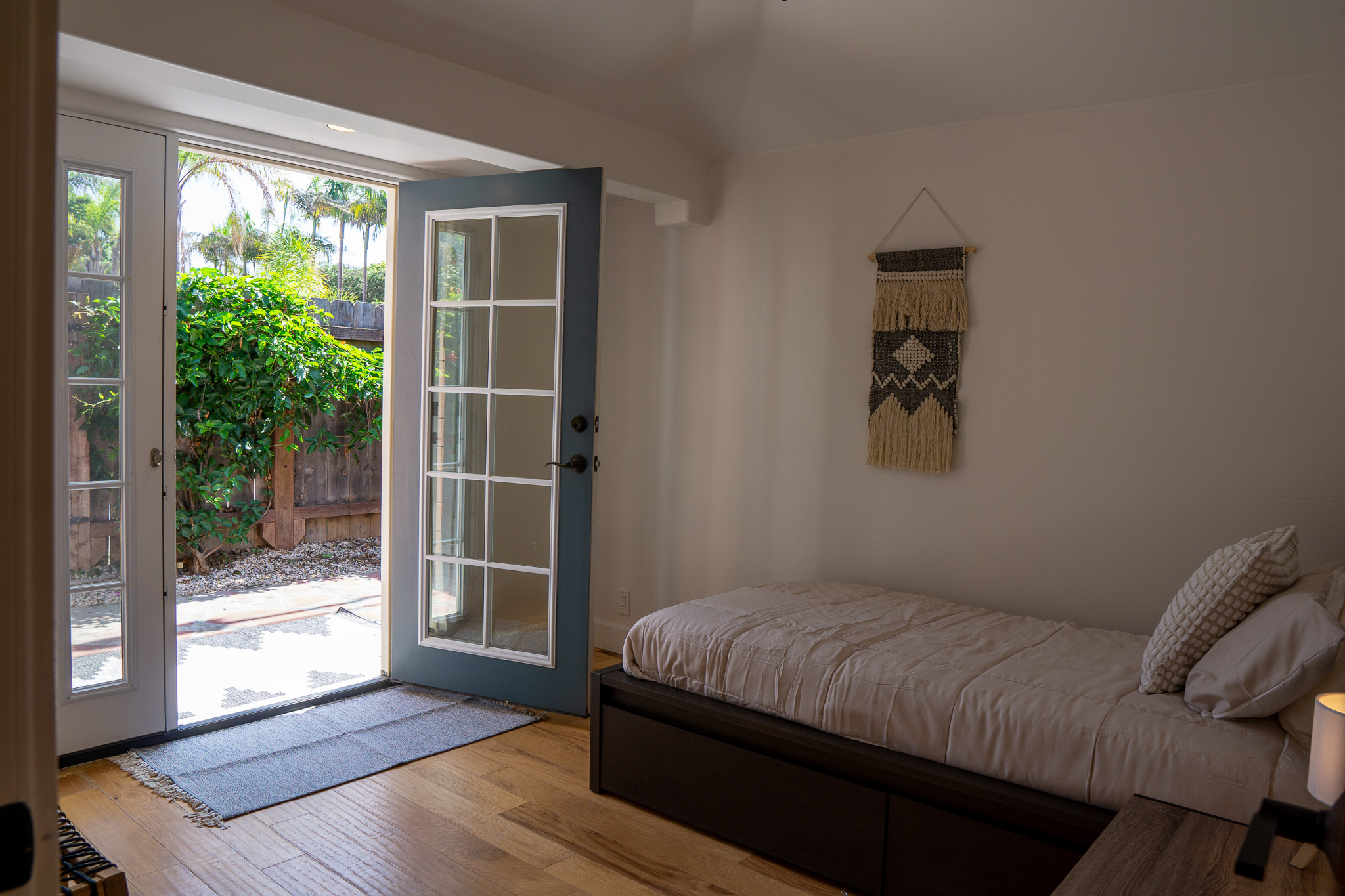 Cozy shared bedroom featuring organized storage, comfortable twin beds, and motivational wall art.