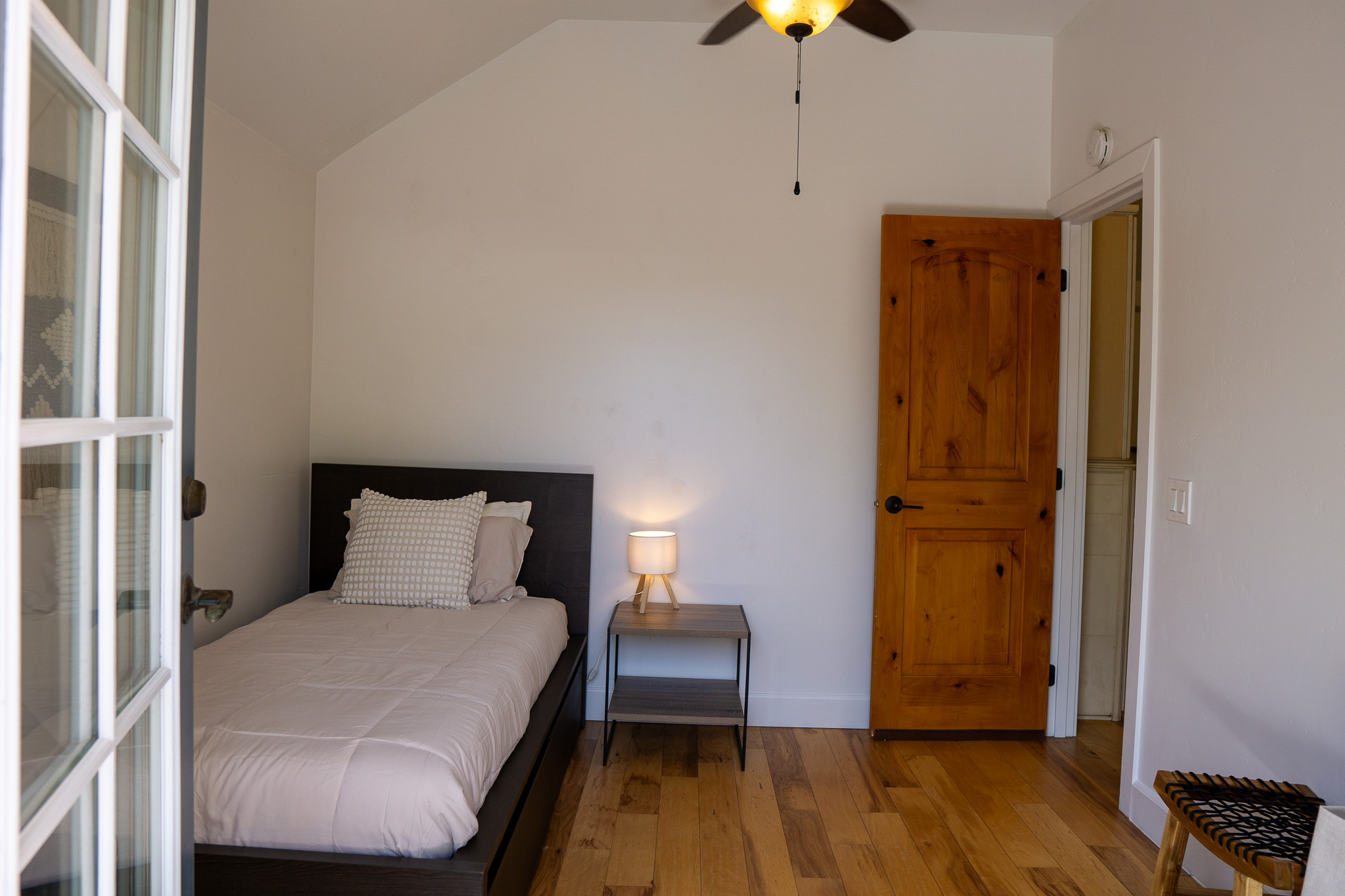 Cozy shared bedroom featuring organized storage, comfortable twin beds, and motivational wall art.