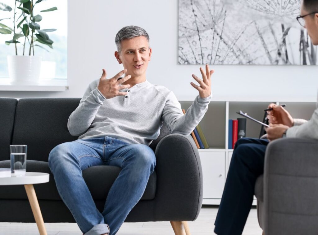 A man converses with a mental health professional during an assessment