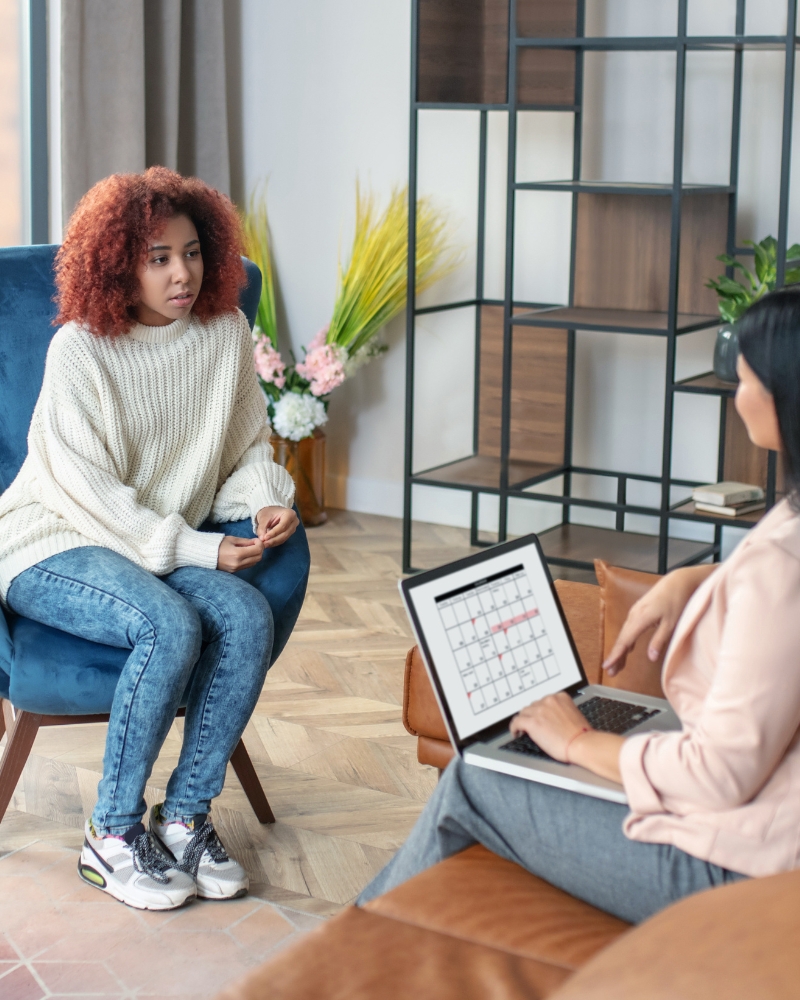 A therapist schedules her next appointment with a client after an addiction assessment