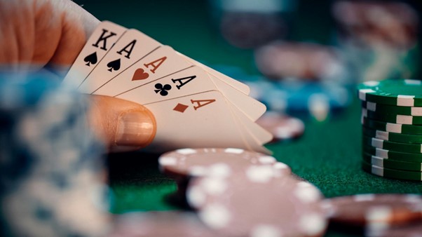 hand holding cards over poker table